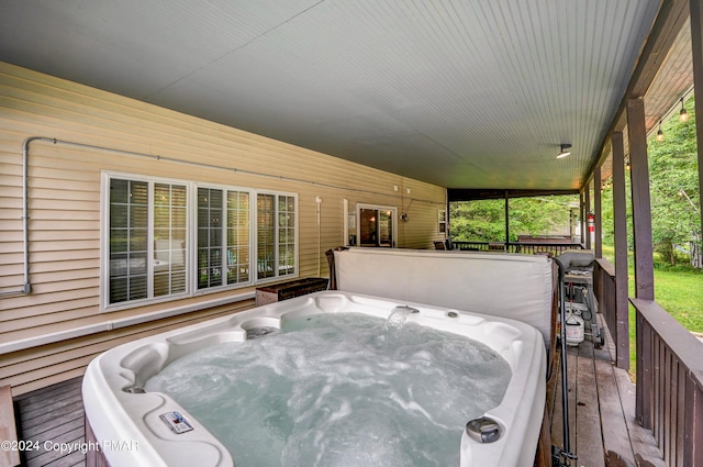 wooden terrace with a hot tub