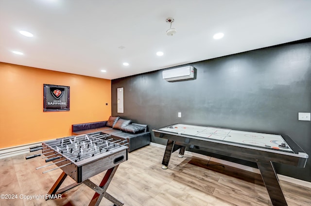 playroom featuring a wall unit AC, electric panel, wood finished floors, and recessed lighting