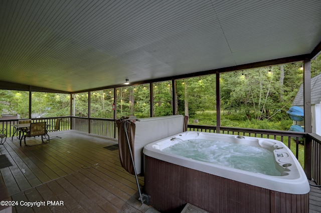 unfurnished sunroom with a hot tub