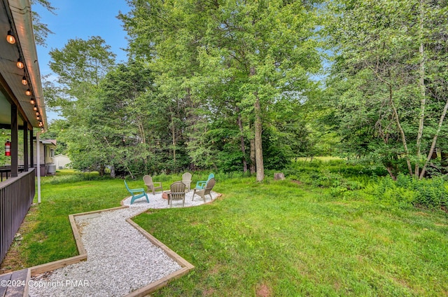 view of yard featuring a patio and a fire pit