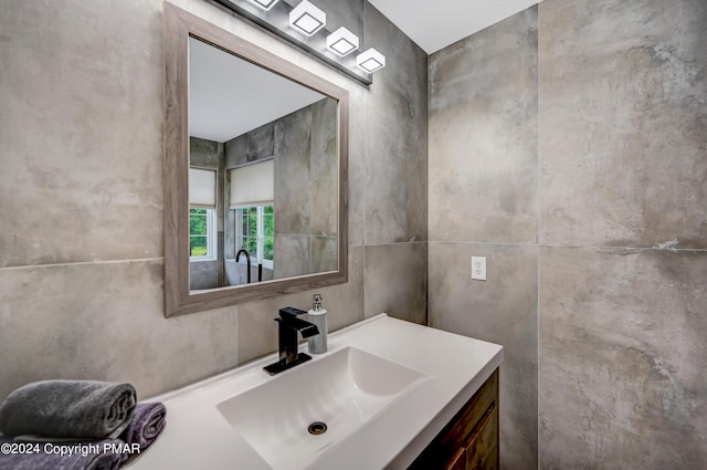 bathroom featuring tile walls and vanity