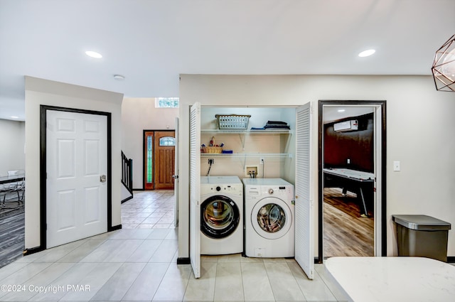 washroom featuring light tile patterned floors, laundry area, washer and clothes dryer, and recessed lighting