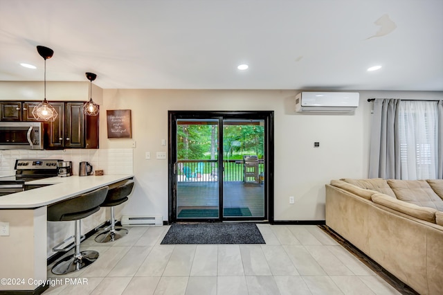 kitchen with dark brown cabinetry, a baseboard heating unit, a breakfast bar, appliances with stainless steel finishes, and backsplash