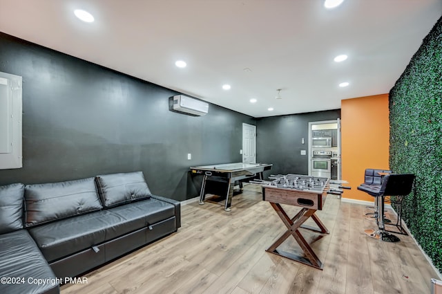 rec room featuring baseboards, a wall mounted AC, wood finished floors, and recessed lighting