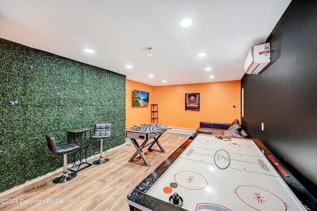 game room with baseboards, a wall unit AC, wood finished floors, and recessed lighting