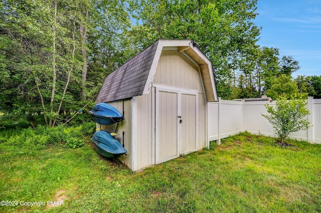 view of shed featuring fence