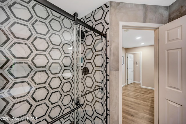 bathroom with baseboards and wood finished floors