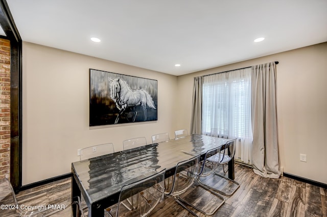 dining space with baseboards, wood finished floors, and recessed lighting