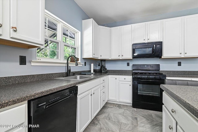 kitchen featuring black appliances, white cabinets, dark countertops, and a sink