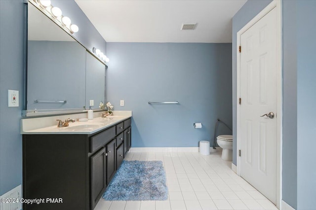 bathroom with a sink, visible vents, toilet, and tile patterned flooring