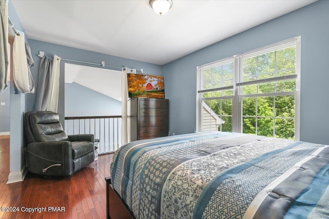 bedroom with baseboards and dark wood-style flooring