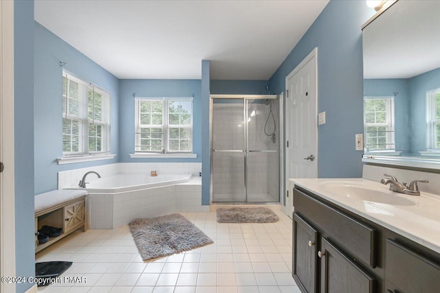 full bathroom featuring tile patterned flooring, a healthy amount of sunlight, a stall shower, and a garden tub