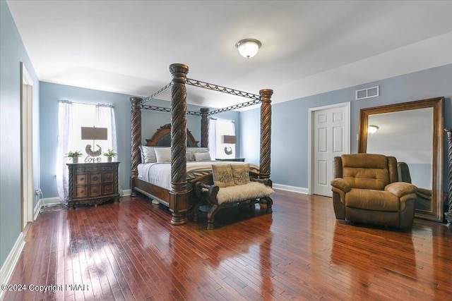 bedroom with visible vents, baseboards, and hardwood / wood-style floors