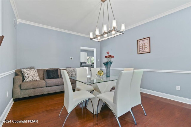 dining room with crown molding, wood finished floors, and baseboards