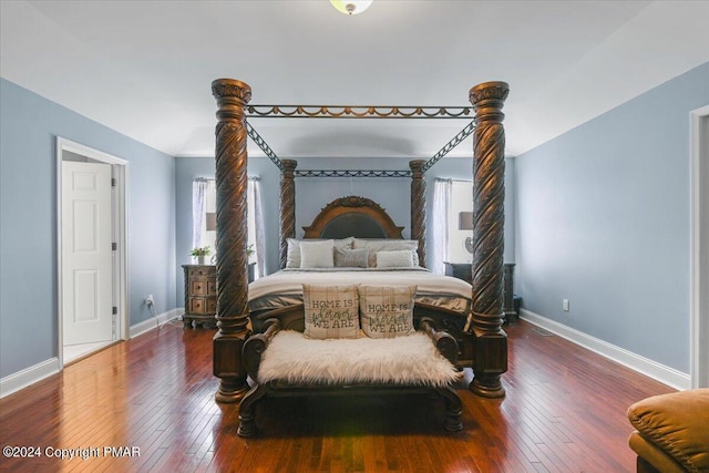 bedroom featuring baseboards and wood-type flooring