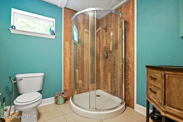 full bath featuring baseboards, toilet, a shower stall, and tile patterned flooring