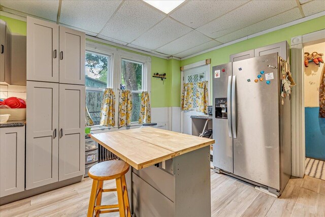 213 N St Fran Cabrini Ave, Scranton, PA 18504 - kitchen with stainless steel refrigerator with ice dispenser, butcher block countertops, a paneled ceiling, light wood-style floors, and wainscoting