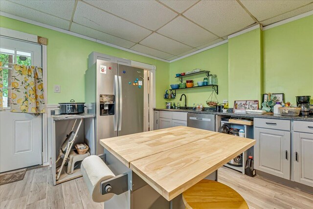 213 N St Fran Cabrini Ave, Scranton, PA 18504 - kitchen featuring a drop ceiling, stainless steel appliances, light wood-style floors, wood counters, and open shelves