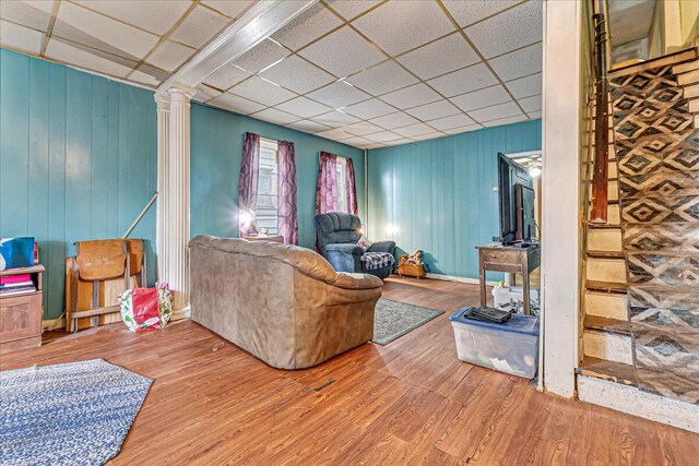 213 N St Fran Cabrini Ave, Scranton, PA 18504 - living area featuring a paneled ceiling, decorative columns, wood finished floors, and wood walls
