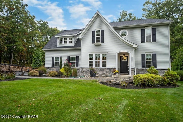 view of front of property with stone siding and a front yard