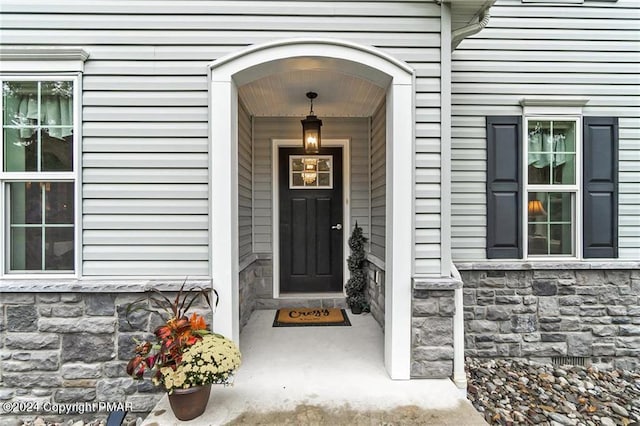 doorway to property with stone siding