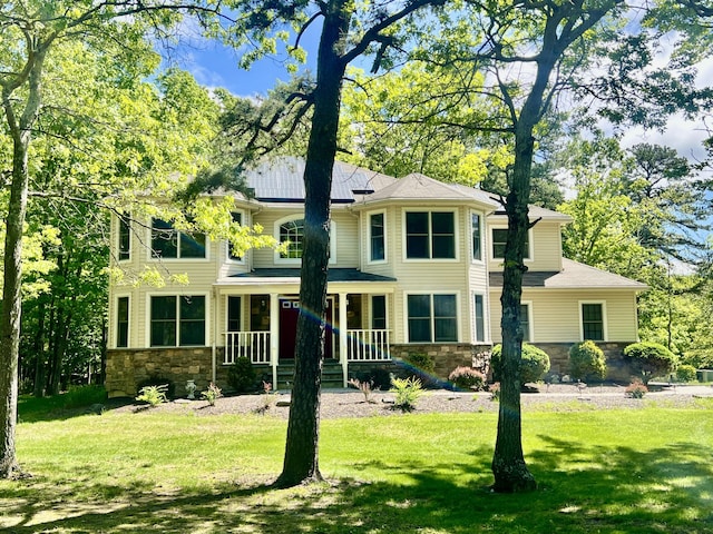 512 Bombur Ln, Tamiment, PA 18371 - view of front facade featuring stone siding, covered porch, and a front yard