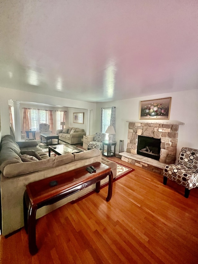 512 Bombur Ln, Tamiment, PA 18371 - living area with wood finished floors, plenty of natural light, and a fireplace
