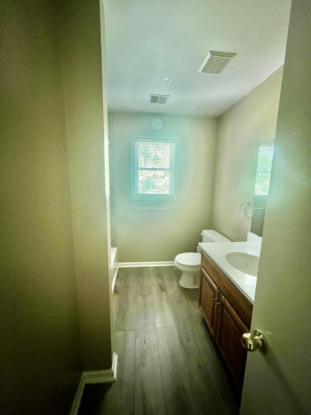 512 Bombur Ln, Tamiment, PA 18371 - full bath with toilet, wood finished floors, vanity, baseboards, and a bath