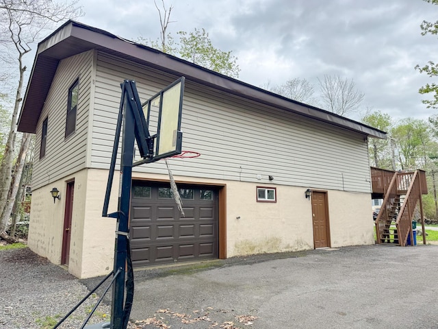 4751 Brentwood Dr, Tobyhanna, PA 18466 - view of home's exterior with stairs, stucco siding, and asphalt driveway