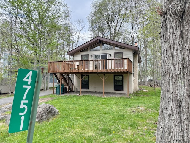 4751 Brentwood Dr, Tobyhanna, PA 18466 - rear view of house with a deck, stairs, a yard, and a chimney