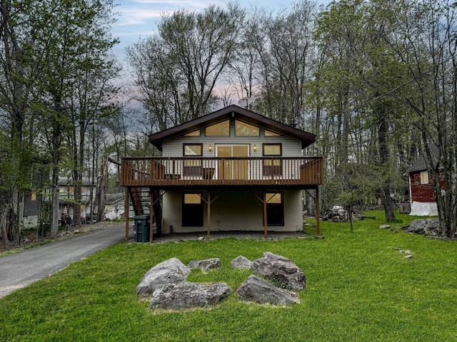 4751 Brentwood Dr, Tobyhanna, PA 18466 - rear view of house with a deck, a lawn, and stairs