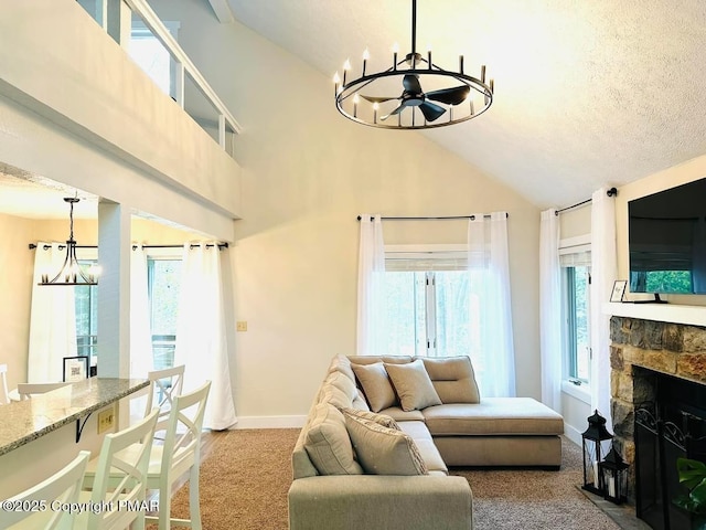 living room featuring a chandelier, plenty of natural light, and a fireplace