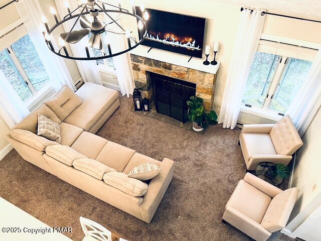 living room featuring carpet flooring and a stone fireplace