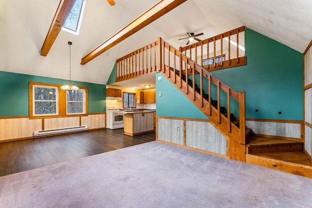 unfurnished living room with a wainscoted wall, stairway, beamed ceiling, dark wood-style flooring, and baseboard heating