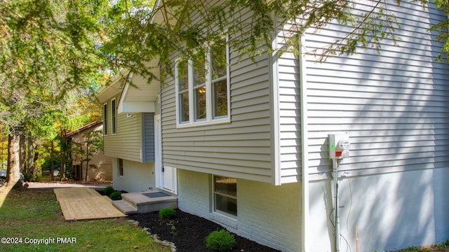 view of side of home with brick siding