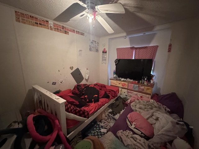 bedroom with a textured ceiling and ceiling fan