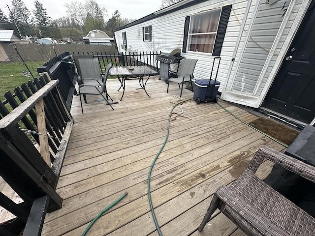 wooden deck with a grill
