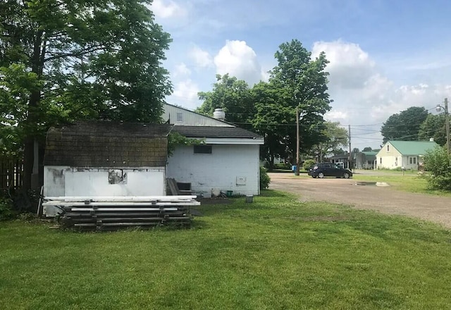 view of side of property with a yard and concrete block siding