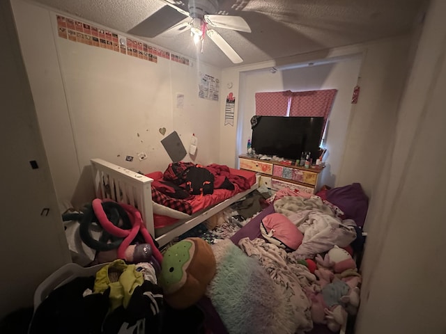 bedroom featuring a ceiling fan and a textured ceiling