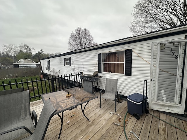 wooden deck featuring a grill