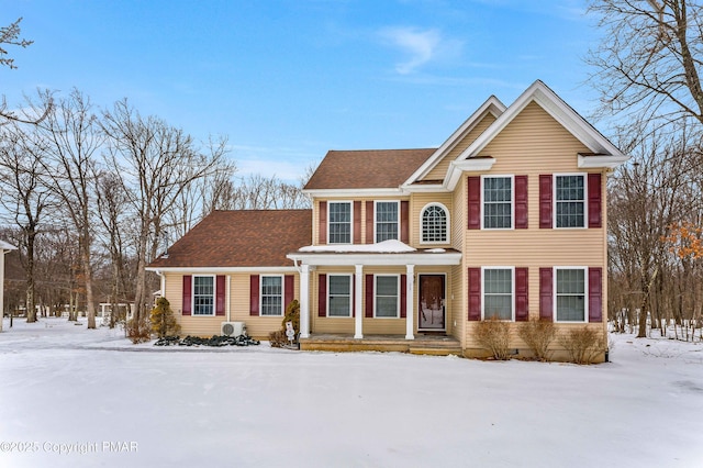 traditional-style home featuring a shingled roof