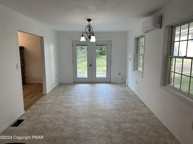 doorway to outside featuring baseboards, visible vents, a wall unit AC, french doors, and a chandelier