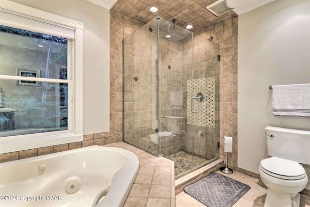 bathroom featuring a jetted tub, tile patterned flooring, toilet, and a stall shower