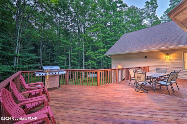 wooden deck featuring grilling area and outdoor dining space