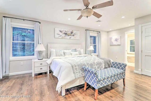 bedroom with visible vents, baseboards, wood finished floors, and recessed lighting