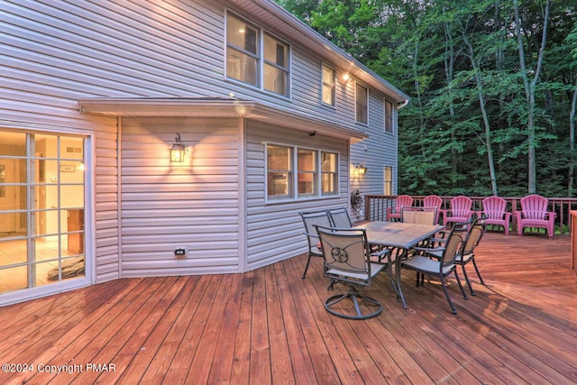 wooden terrace with outdoor dining space