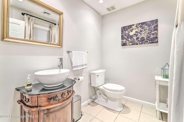 bathroom featuring toilet, baseboards, visible vents, and tile patterned floors