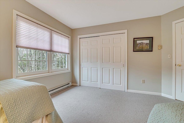 2181 Oak Hill Dr, Buck Hill Falls, PA 18323 - bedroom with light carpet, baseboard heating, baseboards, and a closet