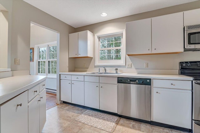 2181 Oak Hill Dr, Buck Hill Falls, PA 18323 - kitchen with a sink, light countertops, a healthy amount of sunlight, and stainless steel appliances