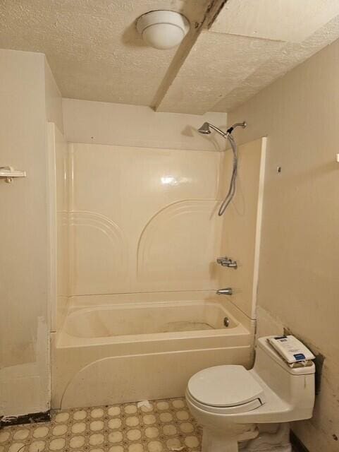 8192 Elk Ct, Tobyhanna, PA 18466 - bathroom featuring a textured ceiling, tile patterned floors, toilet, and bathtub / shower combination